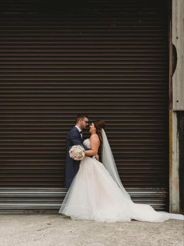 Bride and groom with their wedding flowers