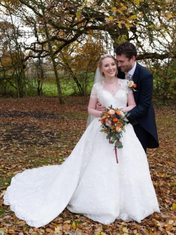 Bride and groom with their wedding flowers