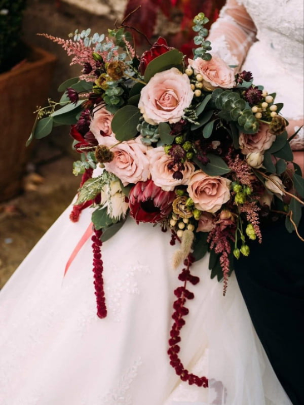 Bride and bridesmaids holding wedding bouquets in Radcliffe