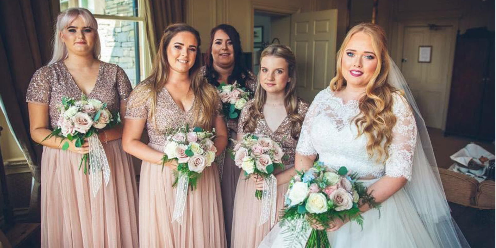 Wedding party with bridal party bouquets at a Radcliffe wedding