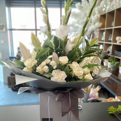 Always Classy - A beautiful handtied in all white with complimentary foliage.