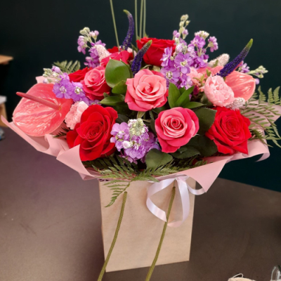 I Heart You - A stunning handtied in red, pink, and purple with complimentary foliage.