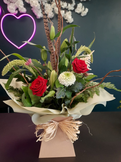 Wild Elegance - A striking contemporary arrangement with natural styling, perfect for making a lasting impression on any special occasion.