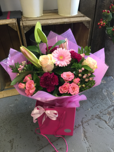 Pretty in Pink - A charming gift bag arrangement in delicate pastel shades, beautifully presented and ready to brighten someone's day.