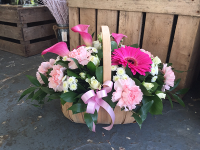 Blushing Arrangement - A charming basket arrangement in soft, elegant tones, perfect for celebrating life's special moments.