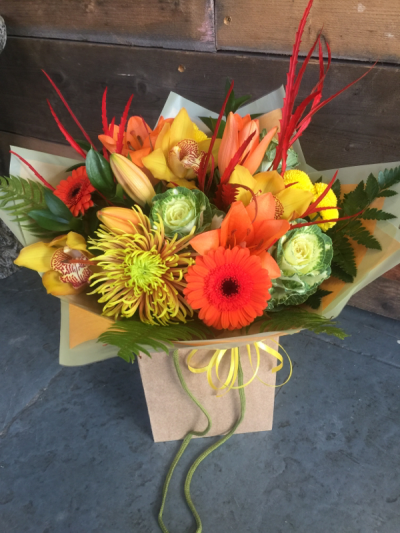 Autumn Glow - A vibrant seasonal bouquet filled with warm, rich tones, beautifully presented in a stylish gift bag.