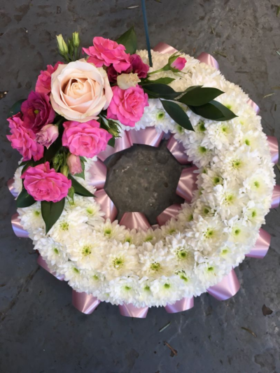 Massed Wreath - A graceful circular tribute in soft, elegant tones, thoughtfully designed to honour a cherished life with love and remembrance.