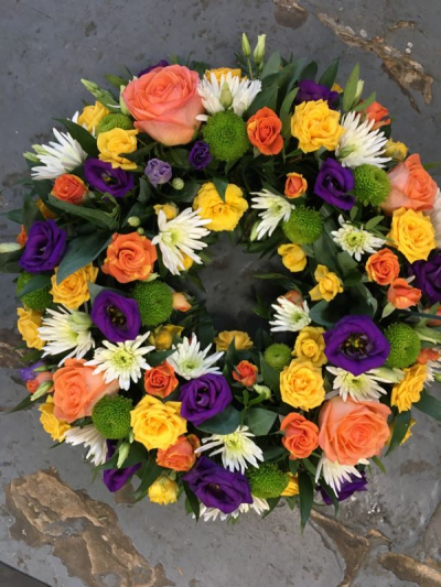 Vibrant Wreath - A vibrant wreath filled with uplifting colour, created to celebrate treasured memories and a life well lived.
