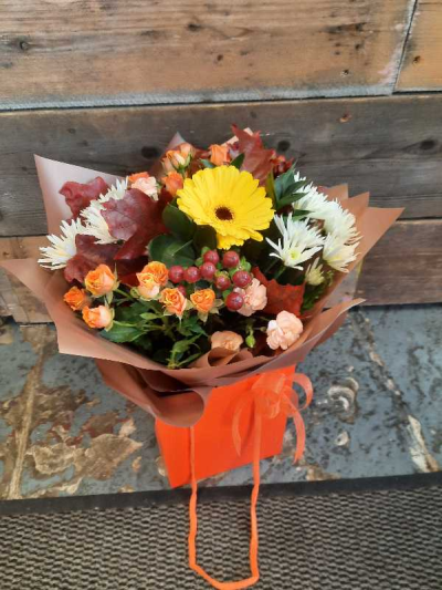 Wild Sunshine - A cheerful seasonal bouquet in warm, rich shades, beautifully presented in a stylish gift bag for any occasion.